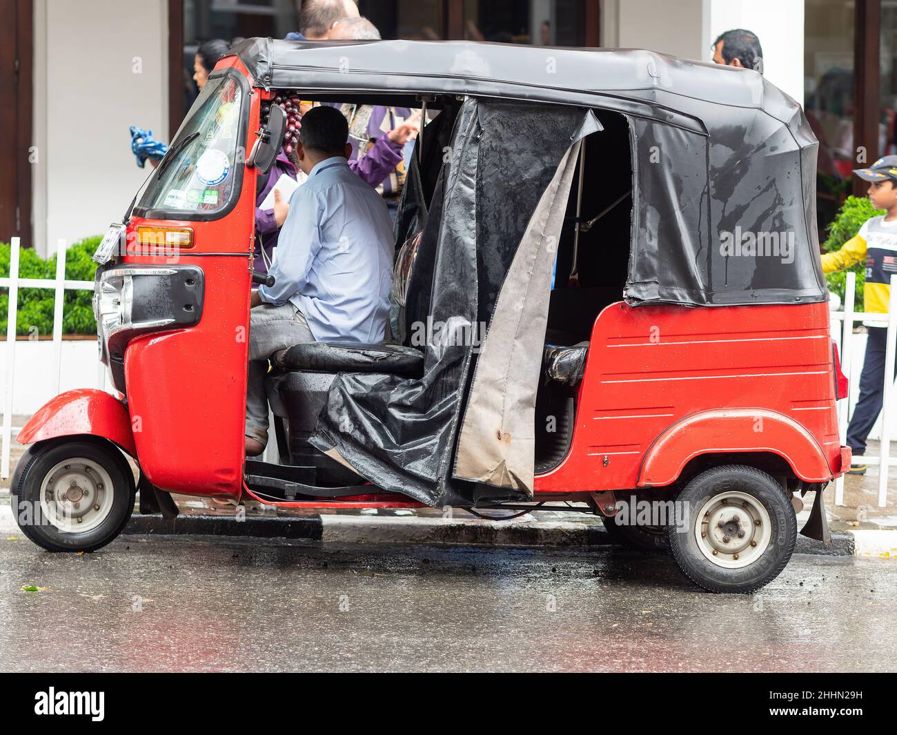 Auto rickshaw waiting for passengers on a rainy day in Kandy, Sri Lanka. Stock Photo
