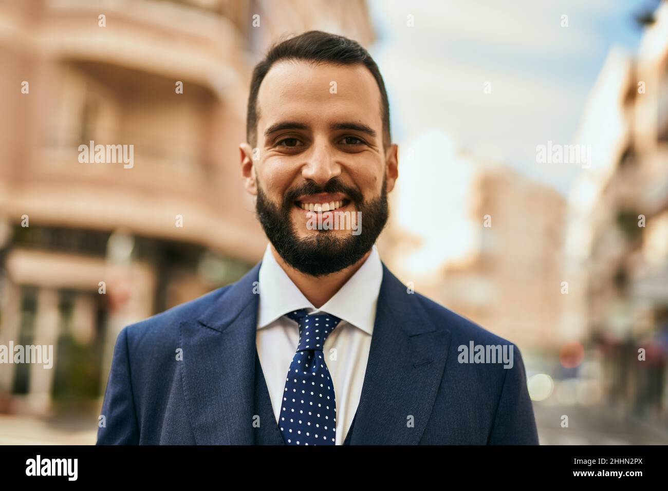 Young businessman smiling happy standing at the city Stock Photo - Alamy