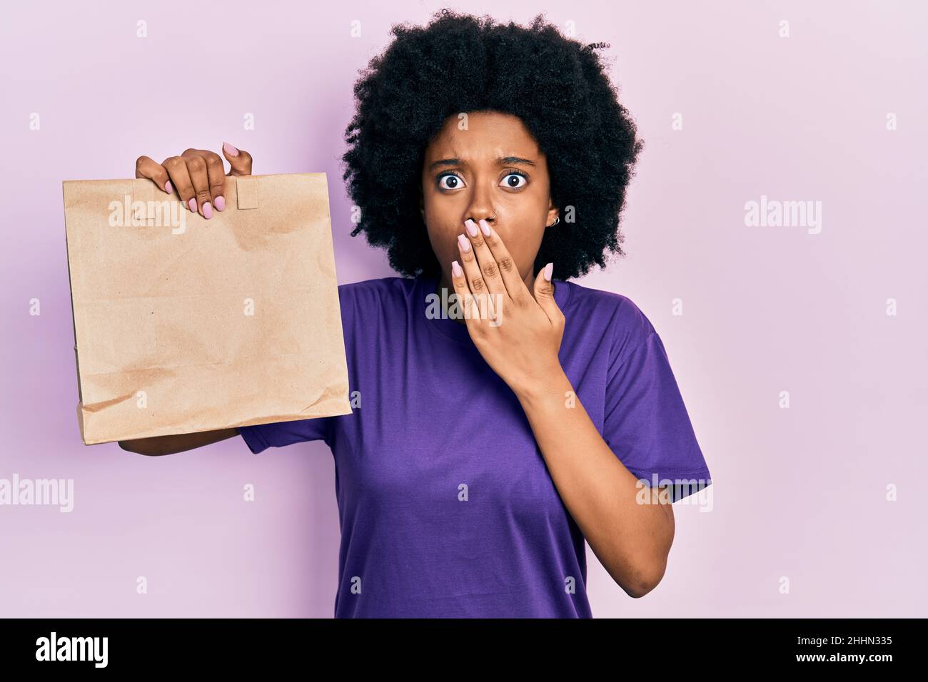 Afraid Paper Young african american woman holding take away paper bag covering mouth ...
