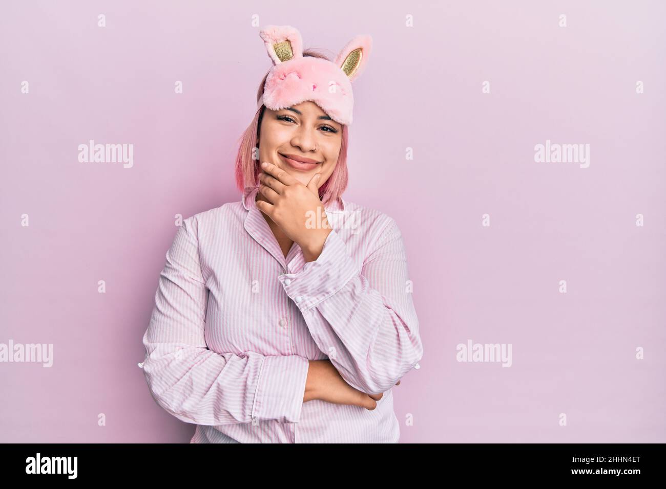 Hispanic Woman With Pink Hair Wearing Sleep Mask And Pajama Looking hispanic-woman-with-pink-hair-wearing-sleep-mask-and-pajama-looking