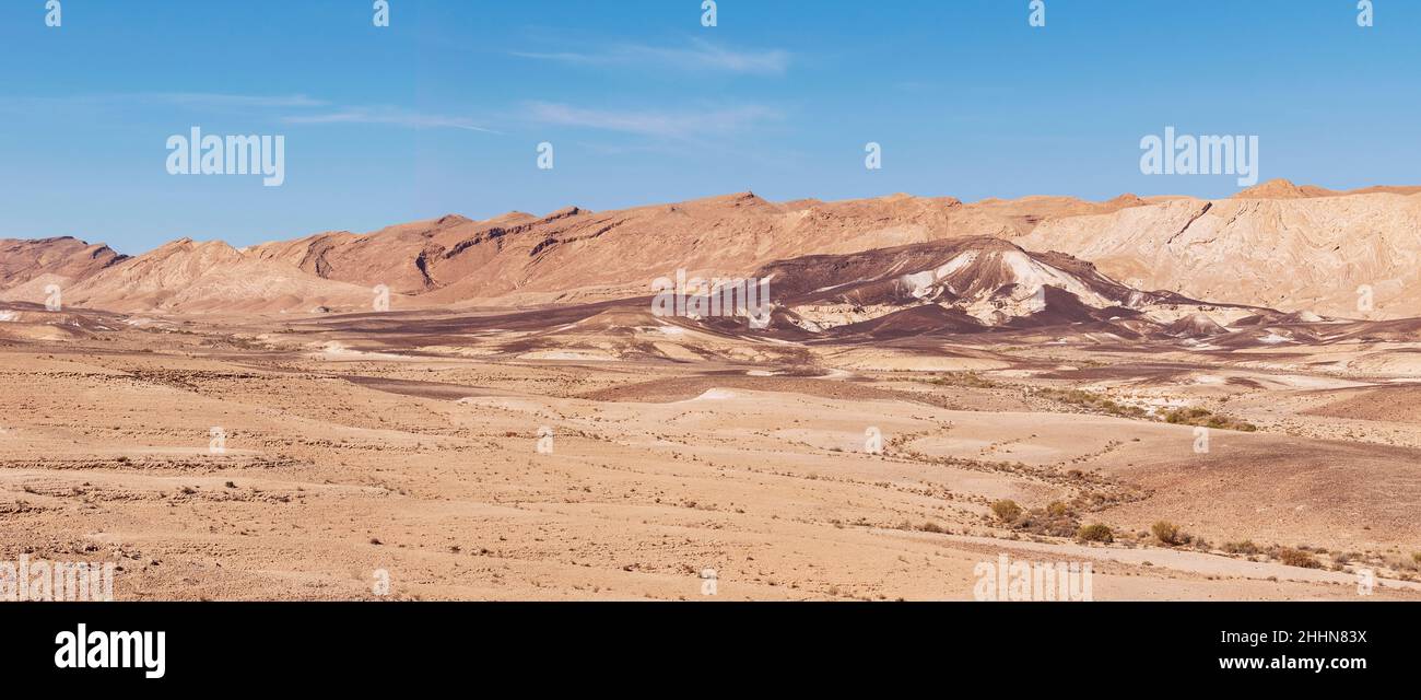 panorama of the bottom of the northwest side of the Makhtesh Ramon erosion crater in the Negev desert in Israel with a blue sky background Stock Photo