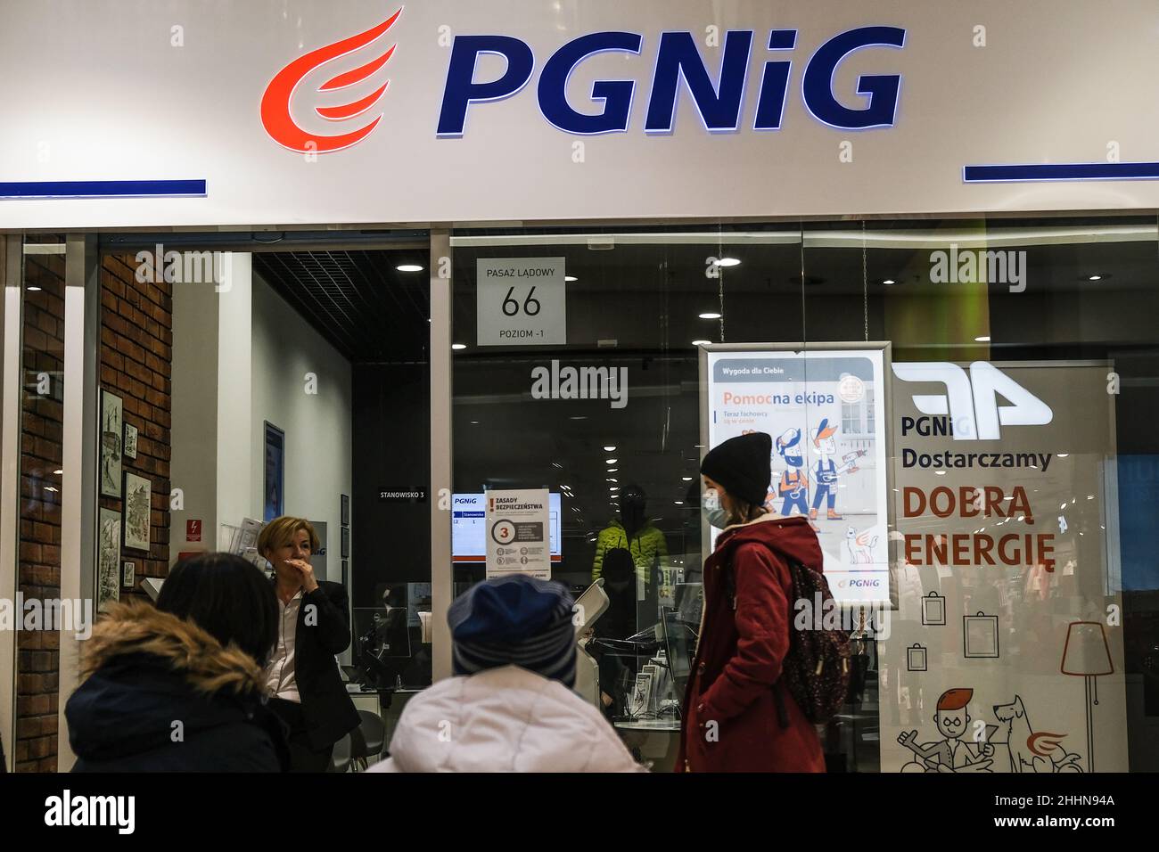 People wait outside the Polish state-controlled oil and gas company (PGNiG) store. Stock Photo