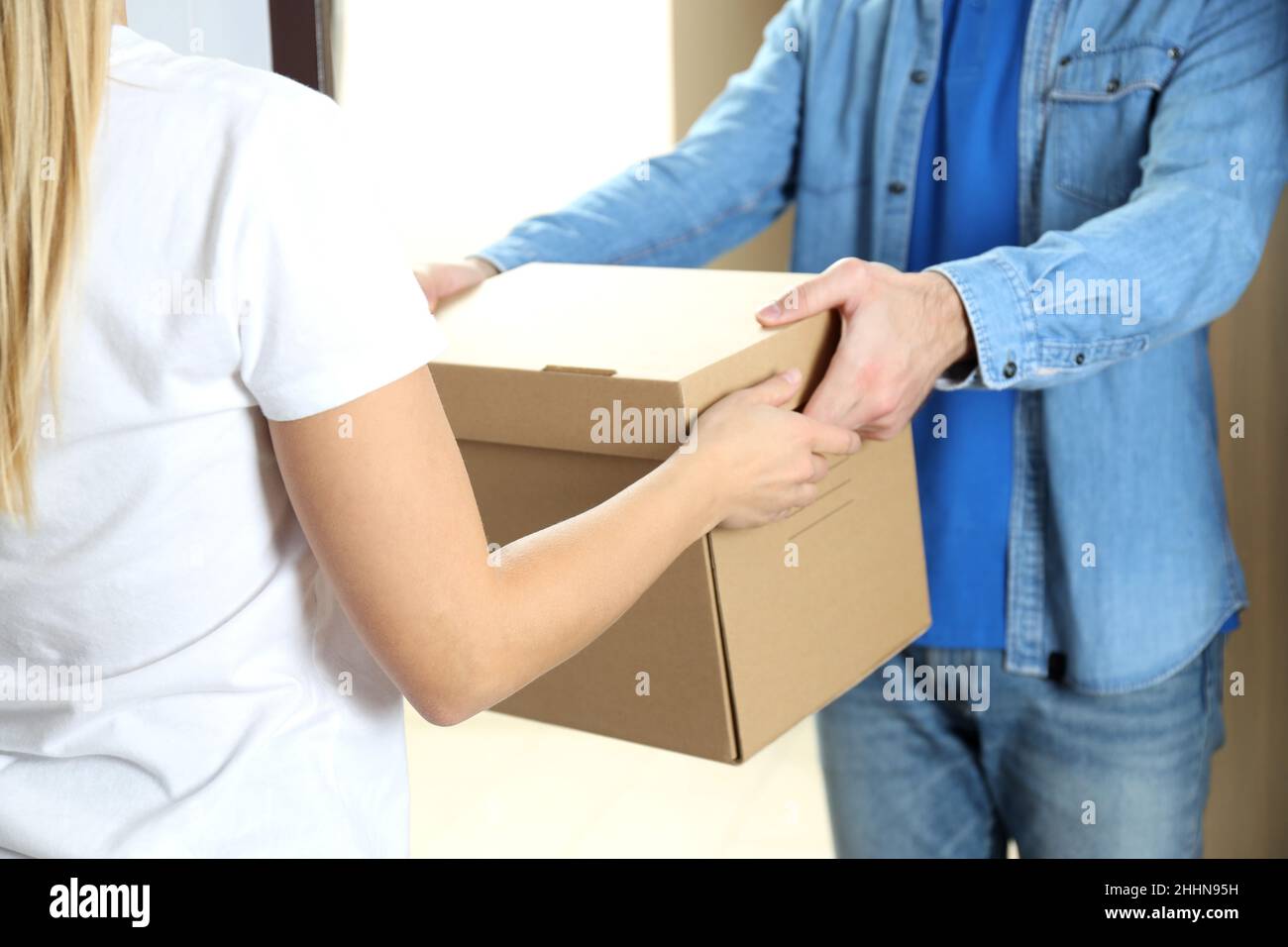 Delivery man gives a box of food to a woman Stock Photo - Alamy