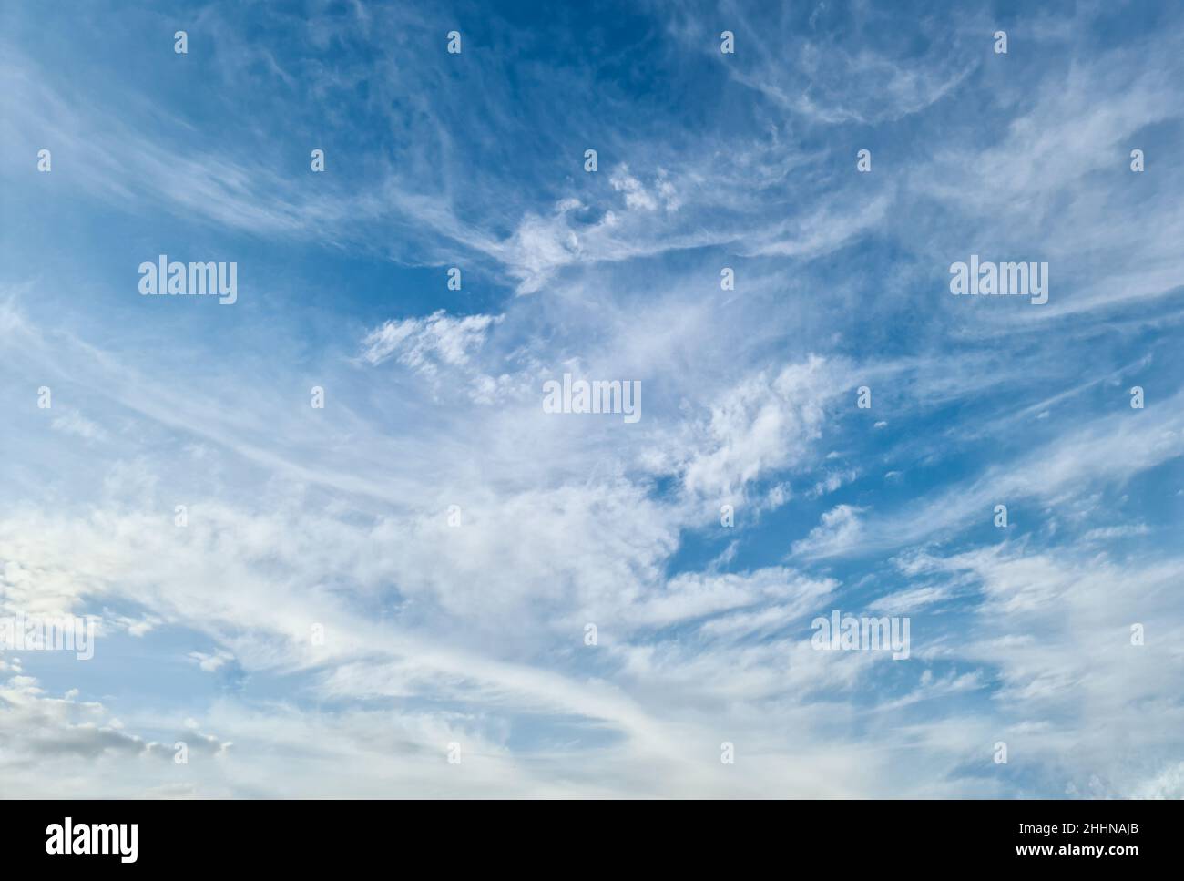 Stunning cirrus cloud formation panorama in a deep blue summer sky seen ...
