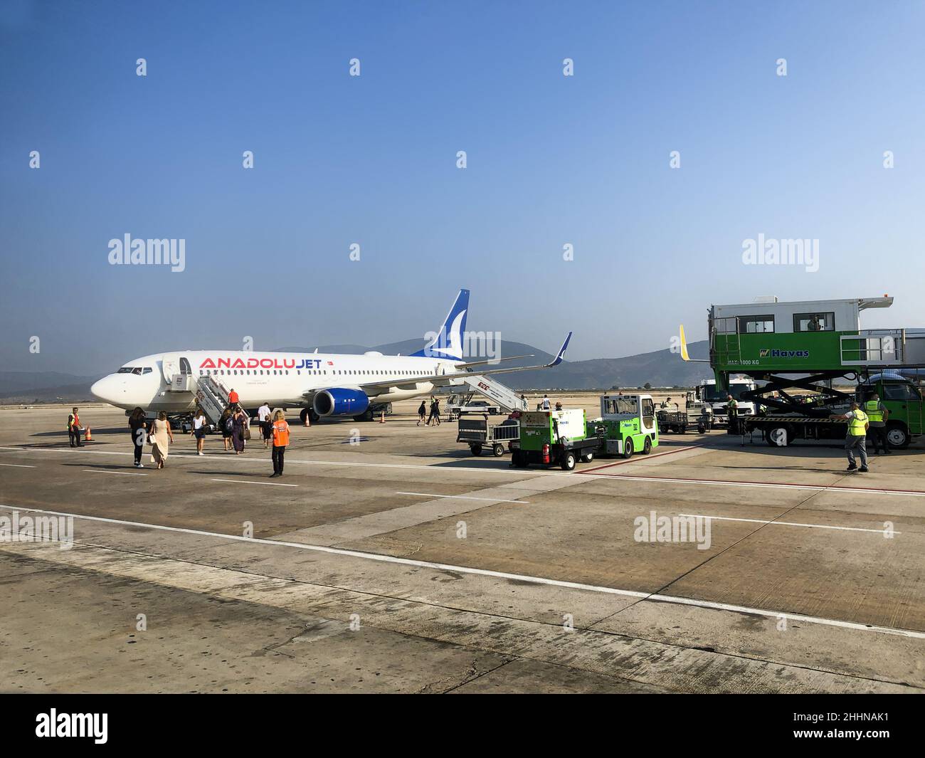 Sabiha Gokcen Airport, Istanbul, Turkey - January 15, 2022: Passengers boarding using stairs airplane of ANADOLU JET, subsidiary of Turkish Airlines Stock Photo