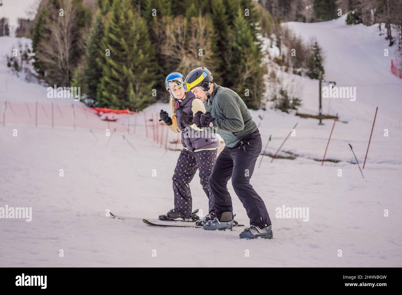 Woman learning to ski with instructor. Winter sport. Ski lesson in alpine school Stock Photo