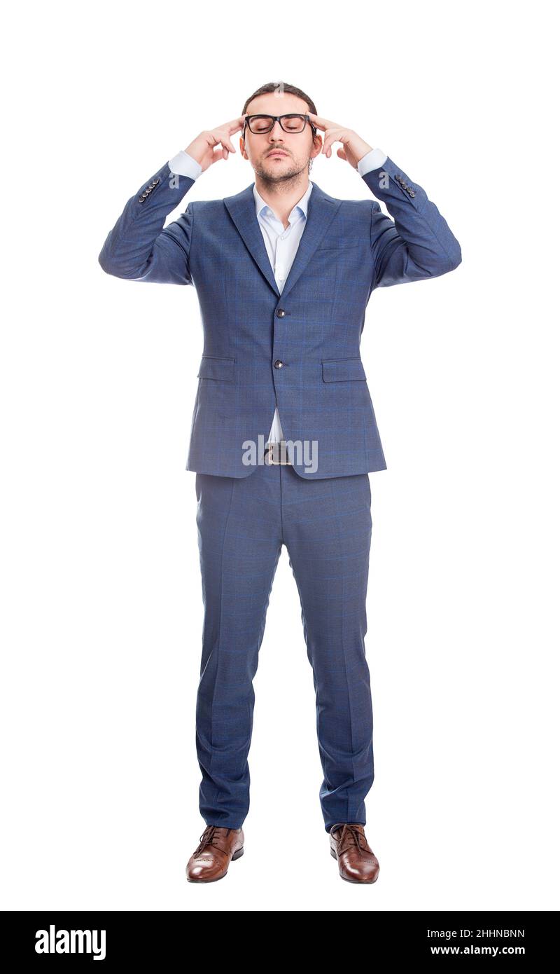 Full length portrait of young businessman keeps hands to temples focusing his thoughts, isolated on white background. Reflective business person plann Stock Photo