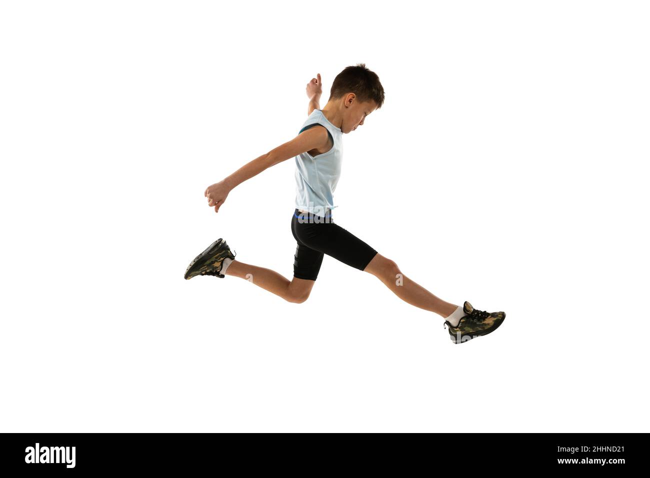 Fullength side view portrait of young boy, running athlete training