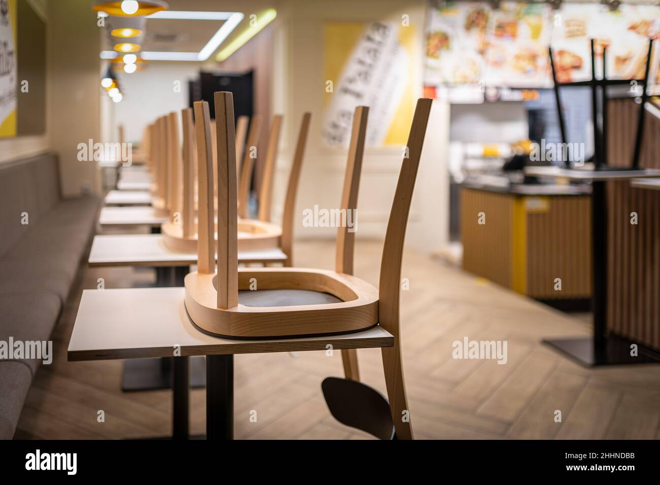 losed restaurant with chairs on tables because of lockdown or shutdown. Stock Photo