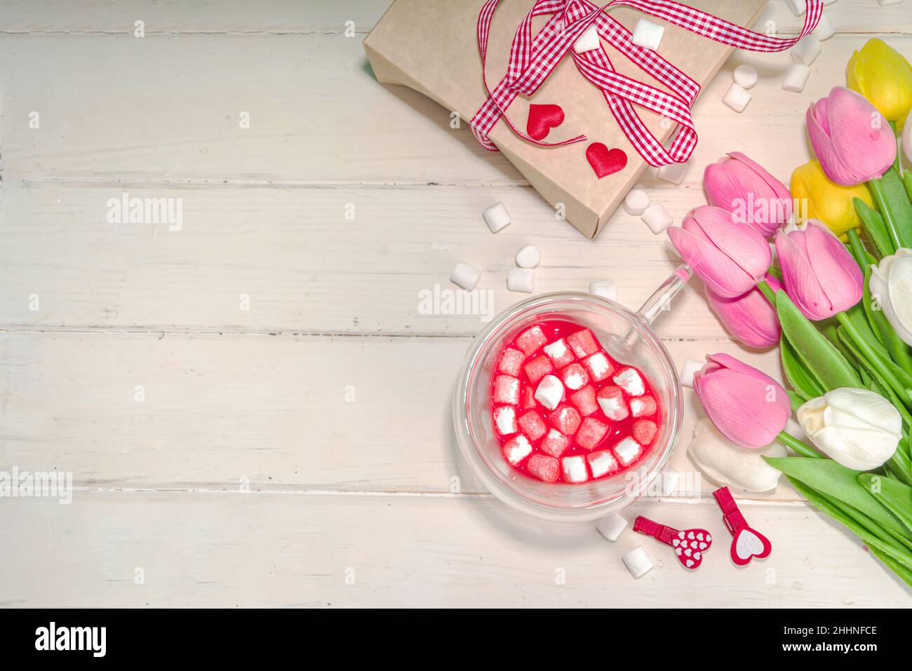 Heart shaped cup with red velvet hot chocolate, with small marshmallows, gift box and flowers for Valentine's day Stock Photo