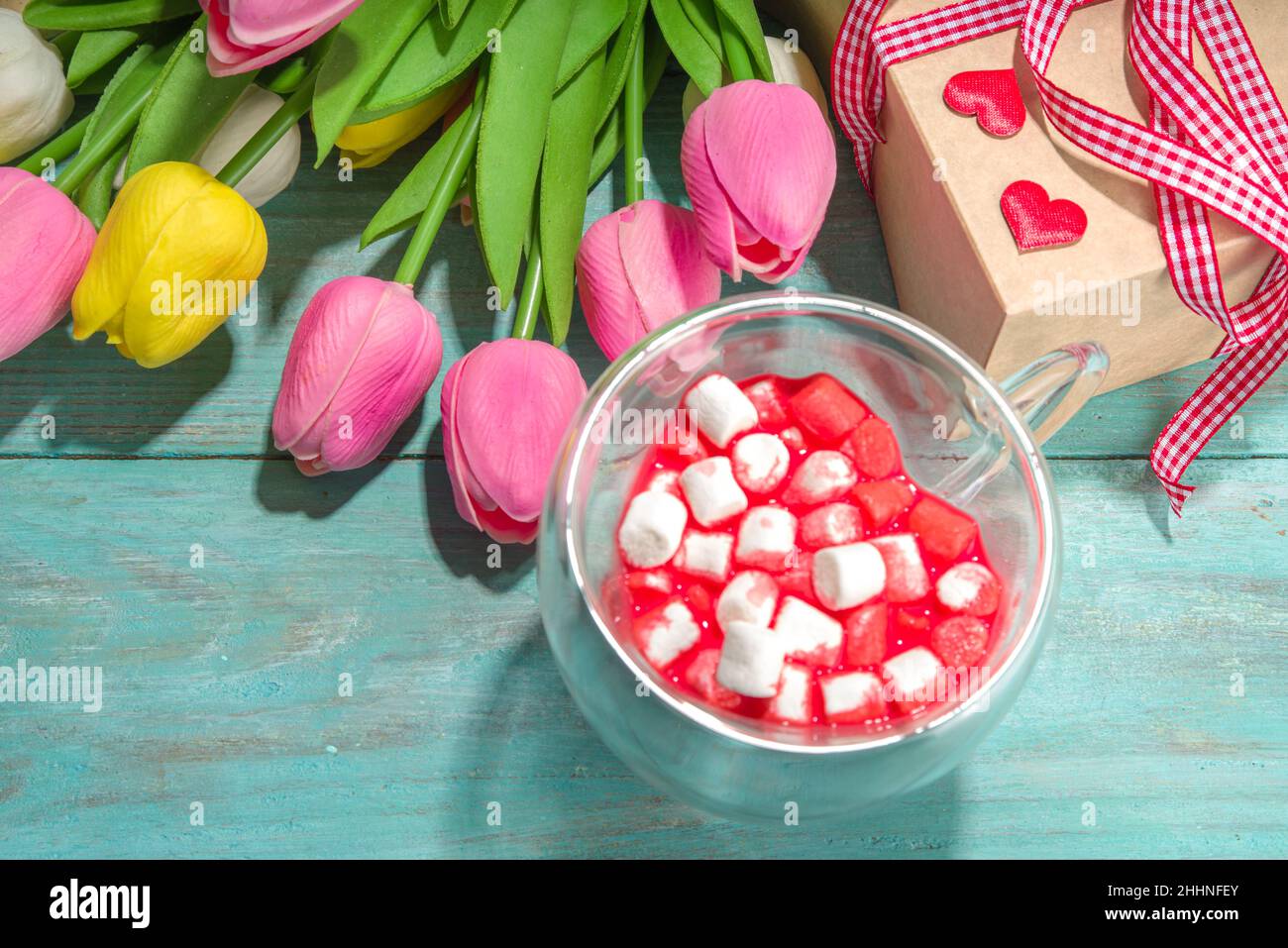 Heart shaped cup with red velvet hot chocolate, with small marshmallows, gift box and flowers for Valentine's day Stock Photo
