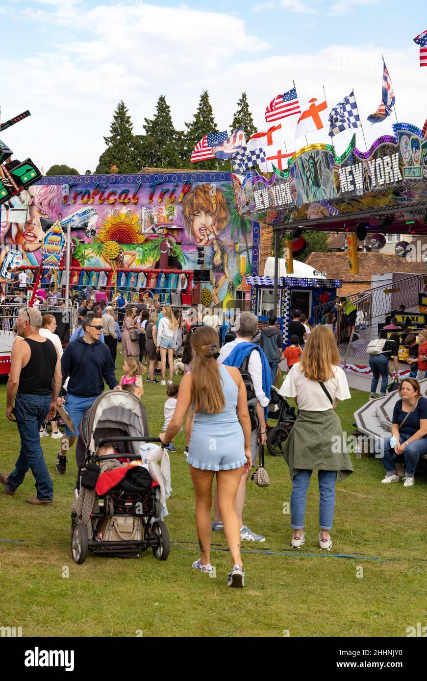 fun fair UK; people with family and children enjoying the funfair on Harpenden Common in summer, Hertfordshire England UK Stock Photo