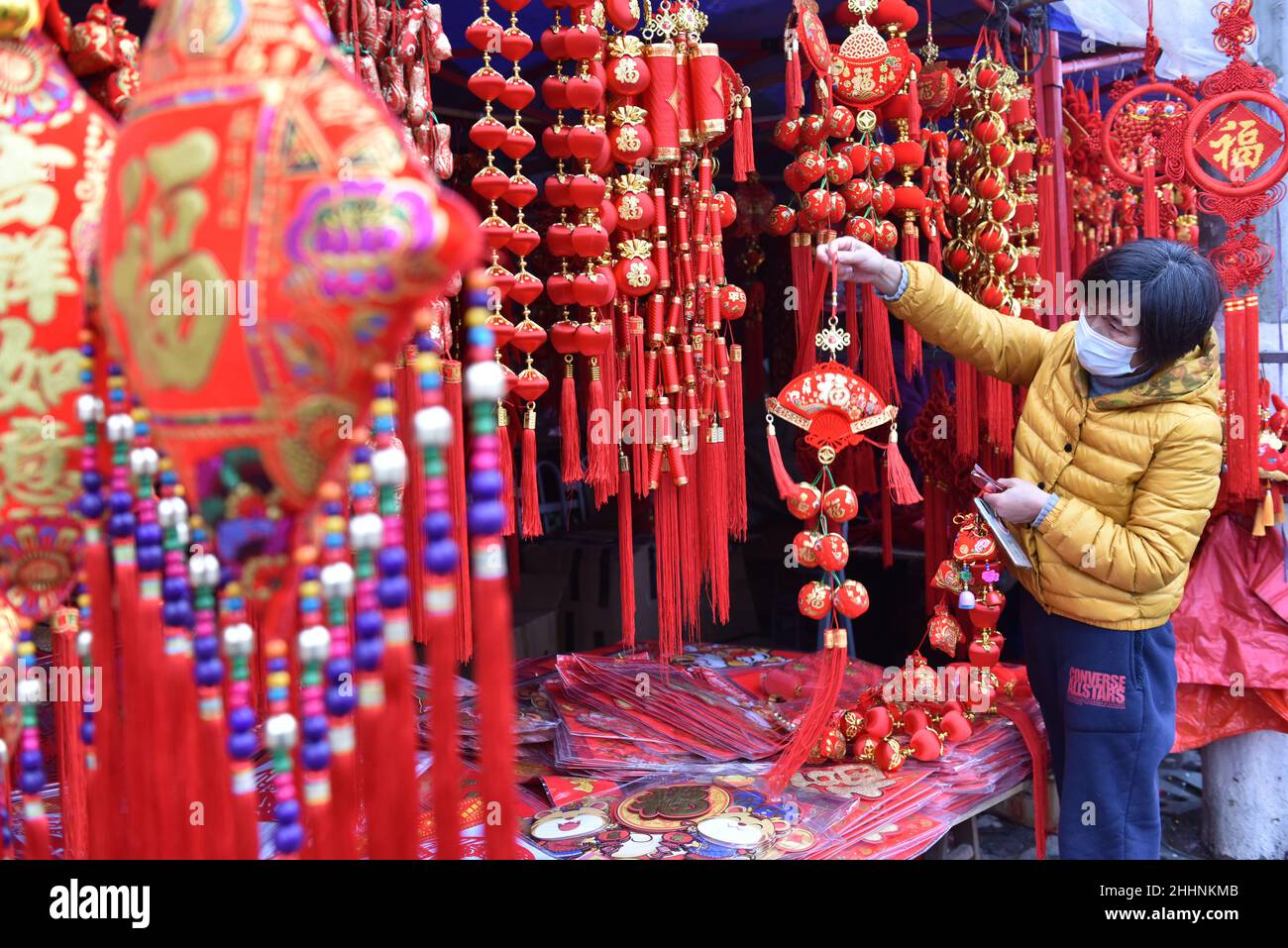 A female customer seen shopping decorations for the Chinese New Year in a market.February 1 this year is the Chinese Lunar New Year. The Chinese Spring Festival is approaching. This year is the year of the tiger in Chinese culture. The number of citizens buying accessories for the year of the tiger Festival has increased significantly. The year of the tiger mascots, red lanterns, 'Fu' characters, Chinese knots and other New Year goods are selling well. The atmosphere of the Spring Festival is getting stronger and stronger. (Photo by Sheldon Cooper / SOPA Images/Sipa USA) Stock Photo