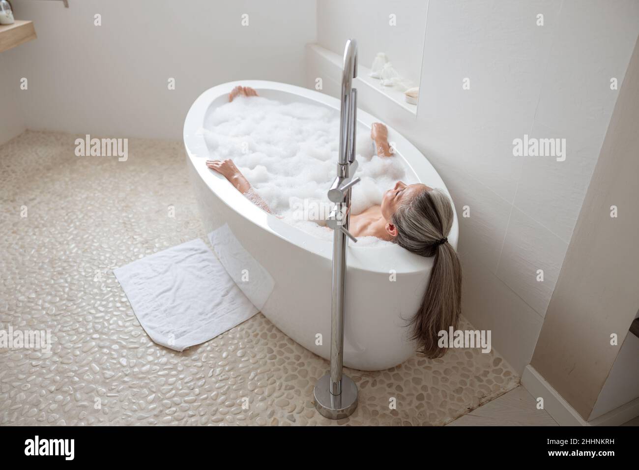 Female lying in the bathtube and resting Stock Photo