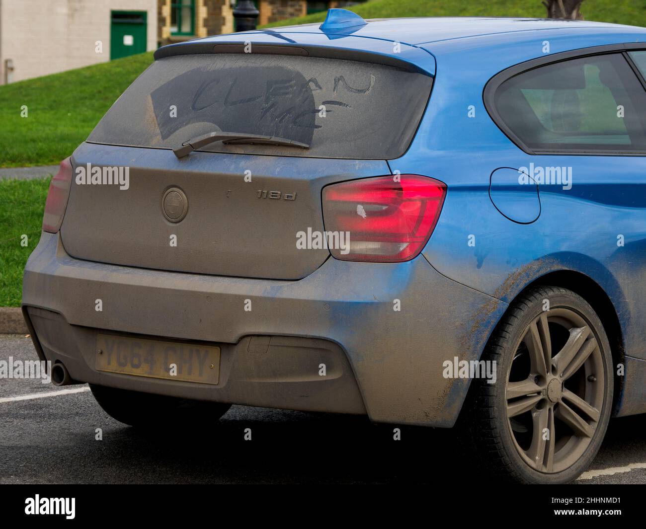 Very dirty car with clean me written on back window, UK Stock Photo