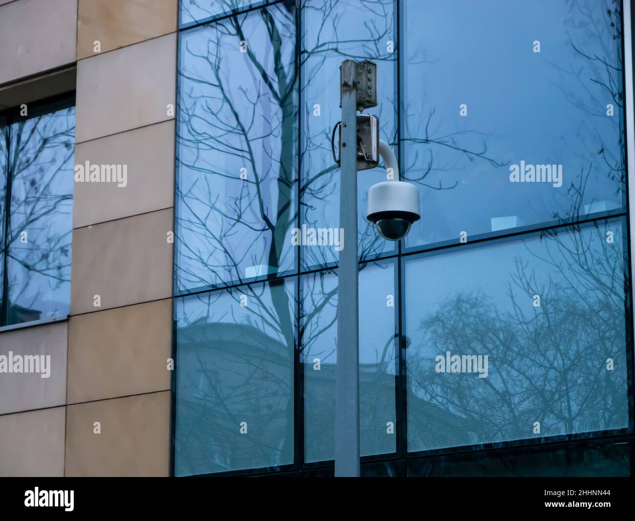 CCTV camera isolated on pillar with glass background Stock Photo