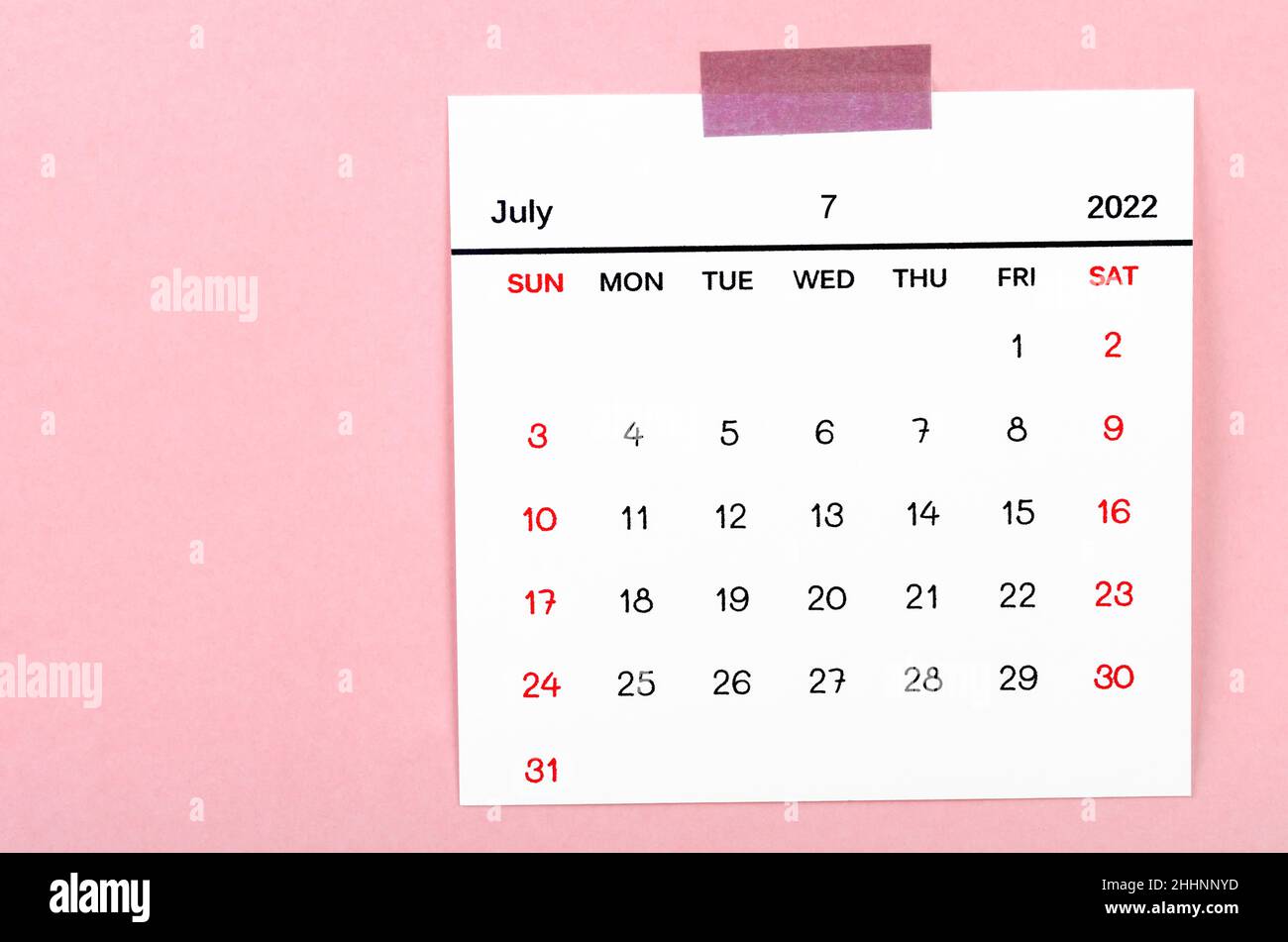 The July 2022 calendar on pink background. Stock Photo