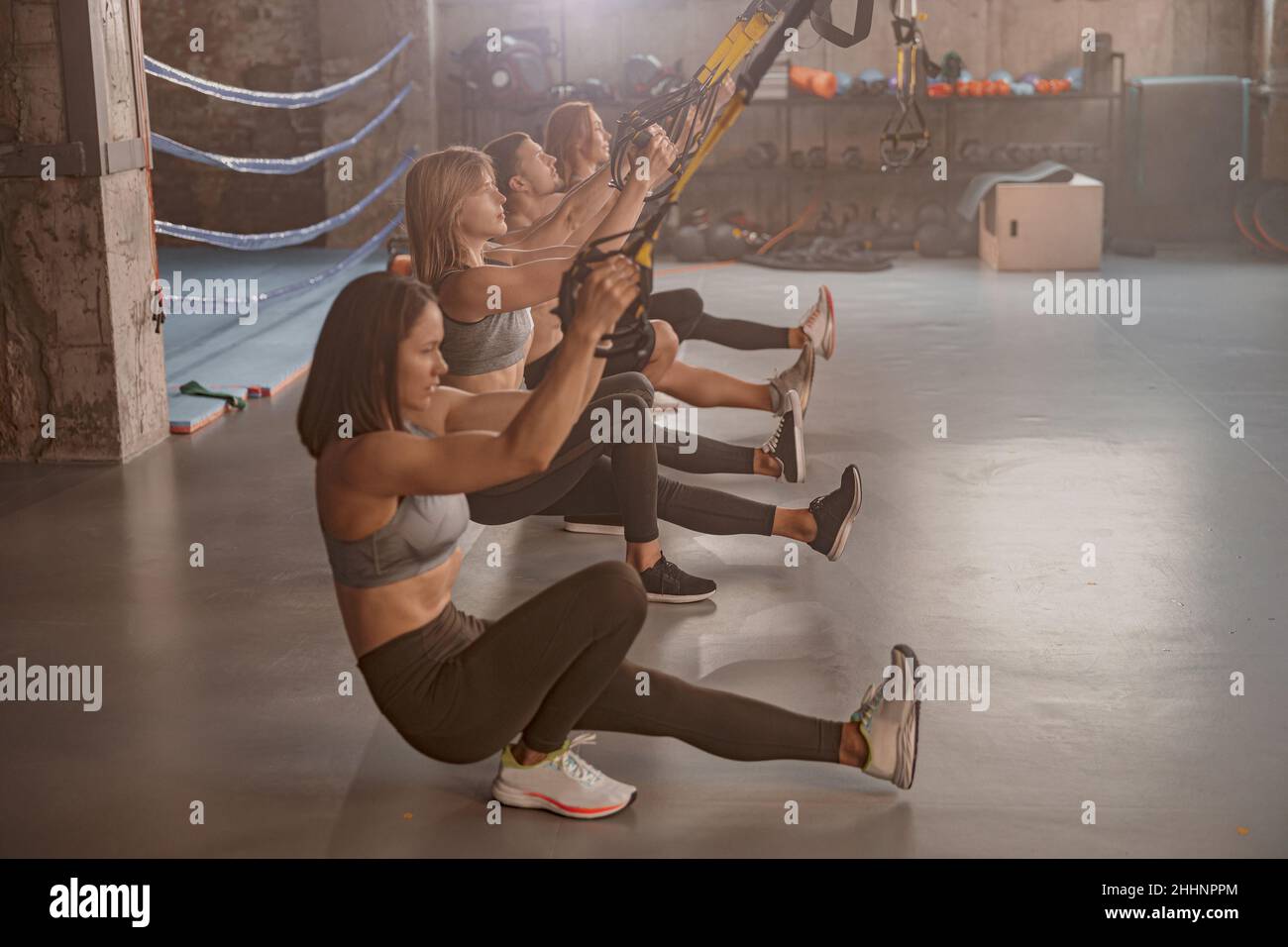 Athletic people doing crossfit training in gym Stock Photo