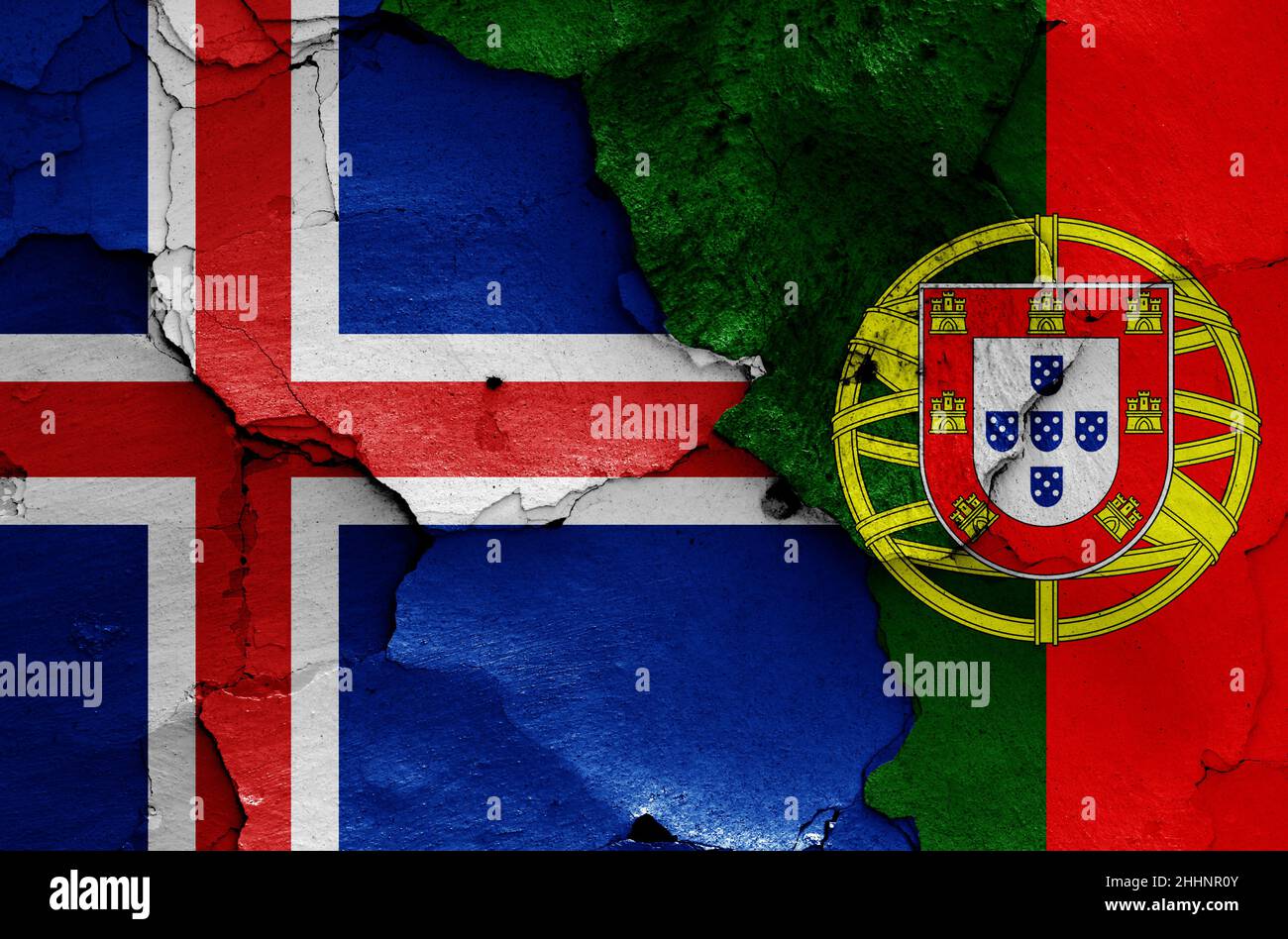 flags of Iceland and Portugal painted on cracked wall Stock Photo