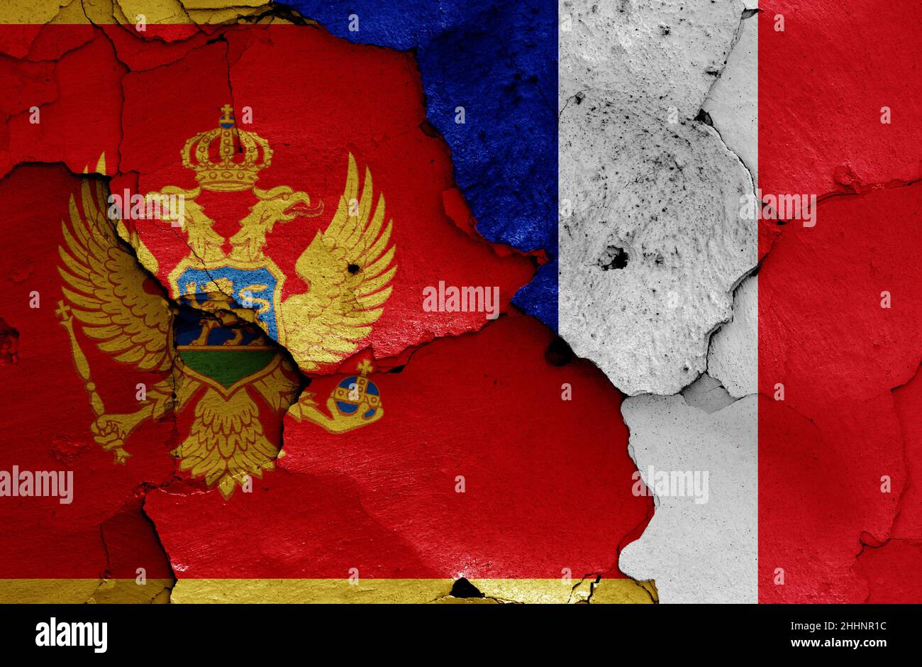 flags of Montenegro and France painted on cracked wall Stock Photo