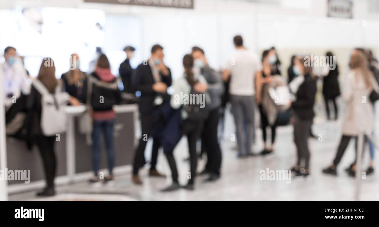 Abstract blured people at exhibition hall of expo event trade show. Business convention show or job fair. Business concept background. Stock Photo
