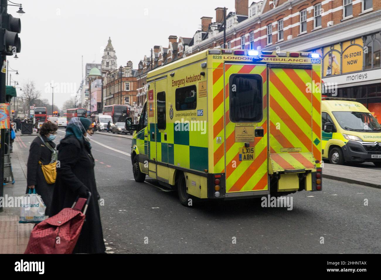 London, UK, 25 January 2022: An emergency ambulance drives through the centre of Brixton. Although coronavirus infection rates remain high nationally, London has passed it's peak and cases in Lambeth have dropped recently. There were 13,810 patients with covid-19 admitted to hospital in the last week. Anna Watson/Alamy Live News Stock Photo