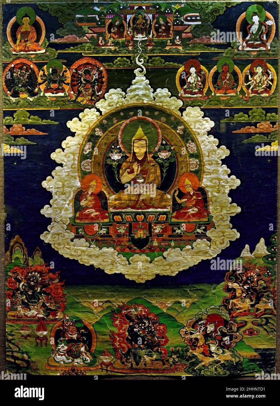 Tsong Kha Pa and the protectors  Tibet tempera on cotton.  ( 15th century saint and scholar of Tibet. Lama Tsongkhapa Typically hung in the grand hall of monasteries, they illustrate how, throughout his previous lives, the Noble Je Tsongkhapa cultivated the Path leading to Enlightenment and how his spiritual progression was attested by prophecies of all the Buddhas of the past. ) Stock Photo