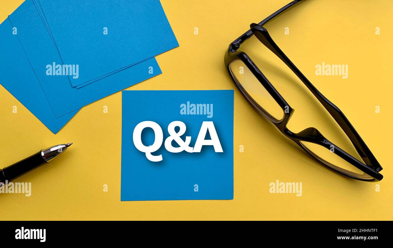Question and answer text on blue notepad with glasses and yellow