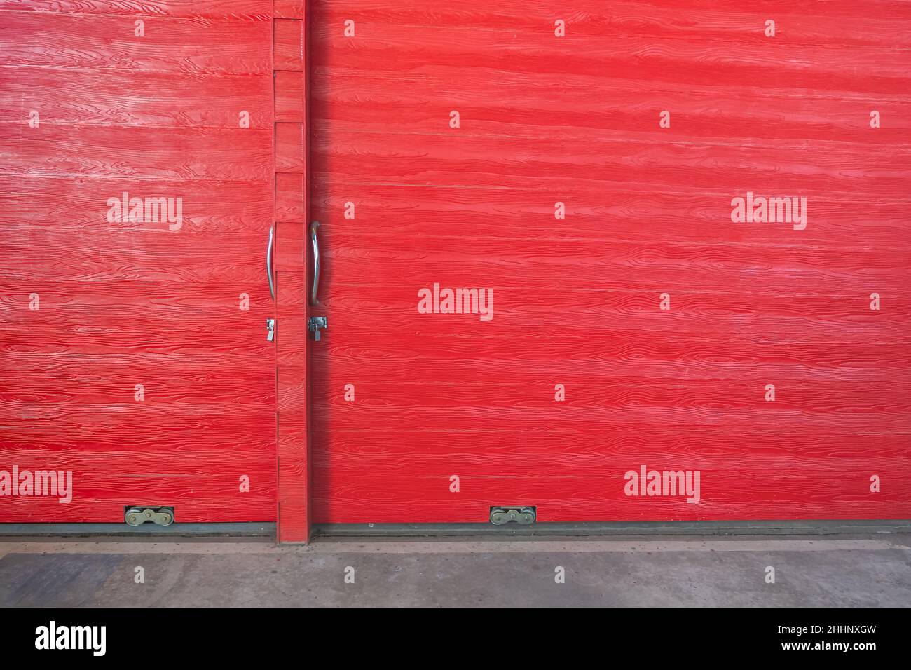 Metal lock and door handle on the red wooden door. Abstract red wood planks background wall texture. Wooden texture red colour for backdrop. Red textu Stock Photo