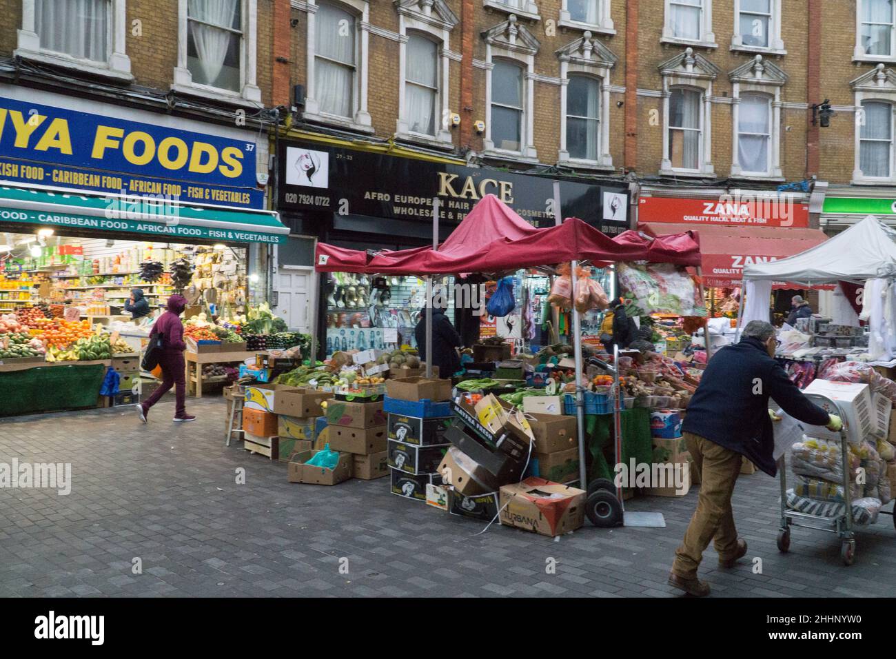 London, UK, 25 January 2022: On Electric Avenue in Brixton people buy groceries from shops and market stalls that cater to the diversity of the local population. The cost of basic foods has risen sharply and there are fears of how the cost of living crisis will affect poorer households all around the country. Anna Watson/Alamy Live News Stock Photo