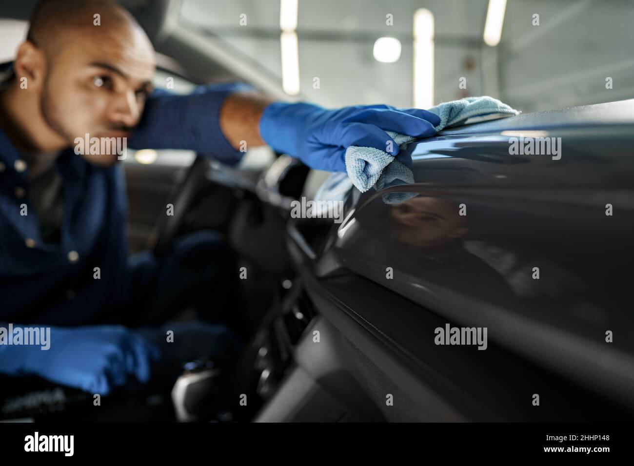 A man cleaning car interior, car detailing in Carwash service Stock Photo