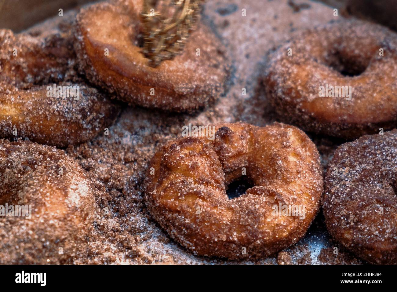 Homemade cinnamon sugar donuts in cast iron skillet outdoors. Stock Photo