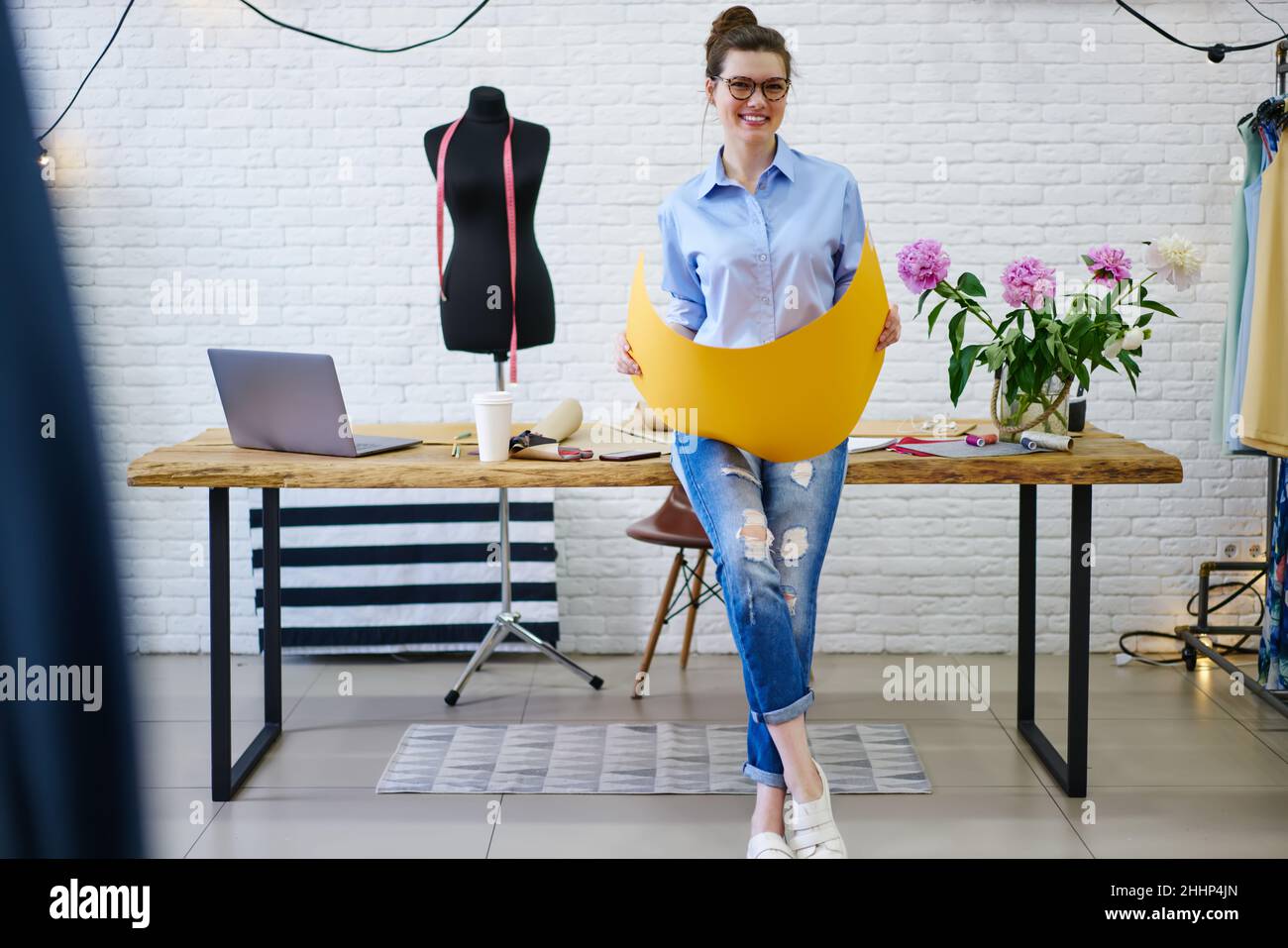 Young smiling woman working in atelier Stock Photo