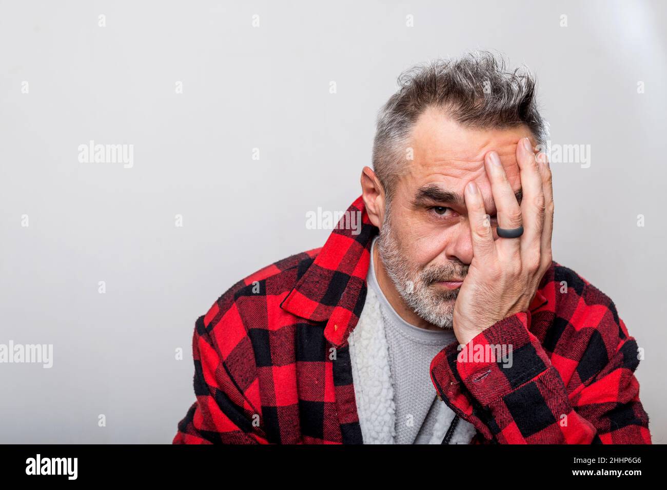 Emotion Portrait of a man in a warm buffalo check lumberjack shirt Stock Photo