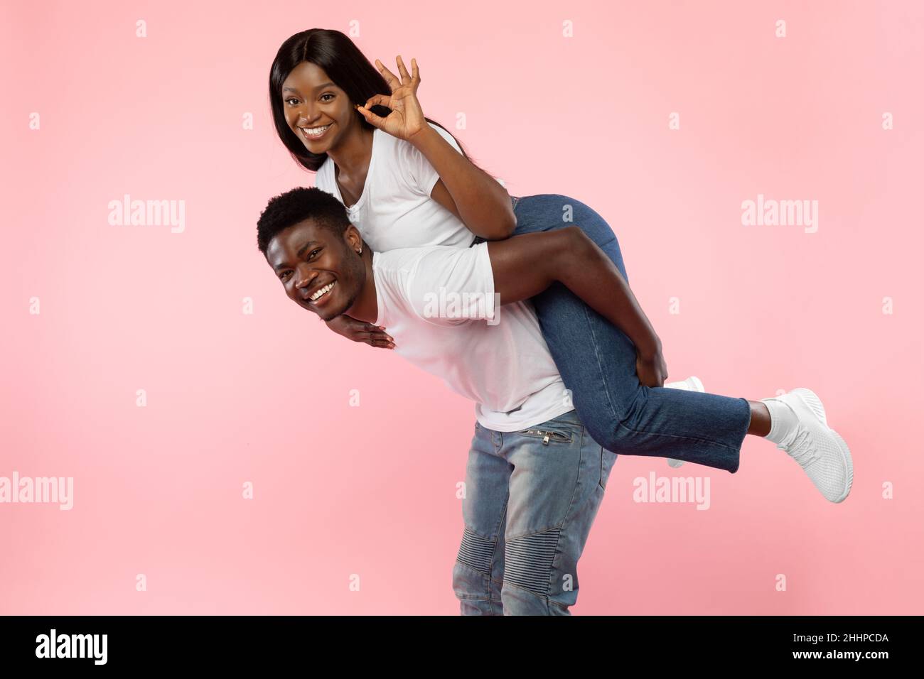 Happy black couple gesturing okay and having fun Stock Photo