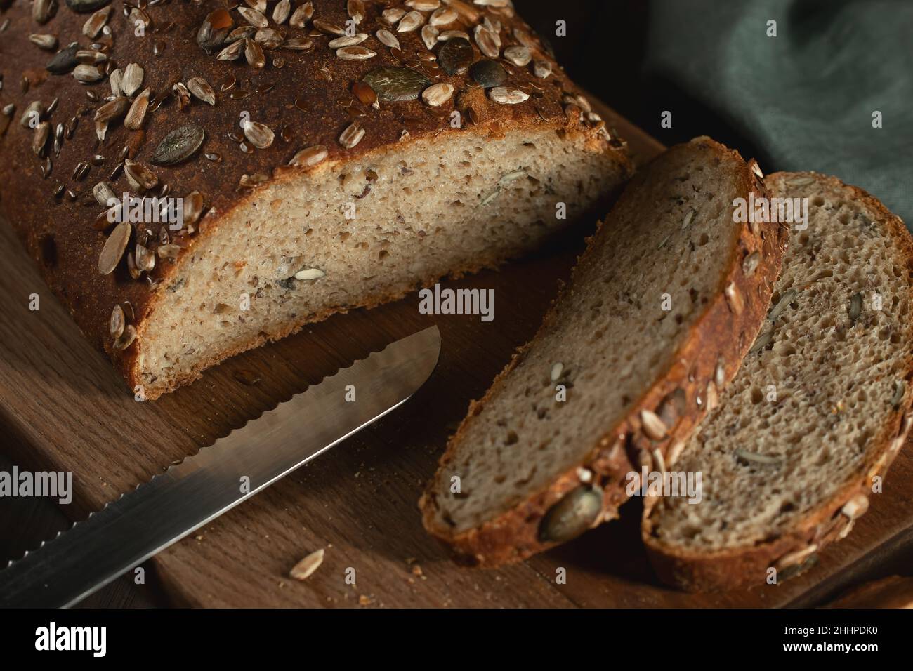 Sliced Homemade Whole Grain Bread with Seeds on a Cutting Board. Stock Photo