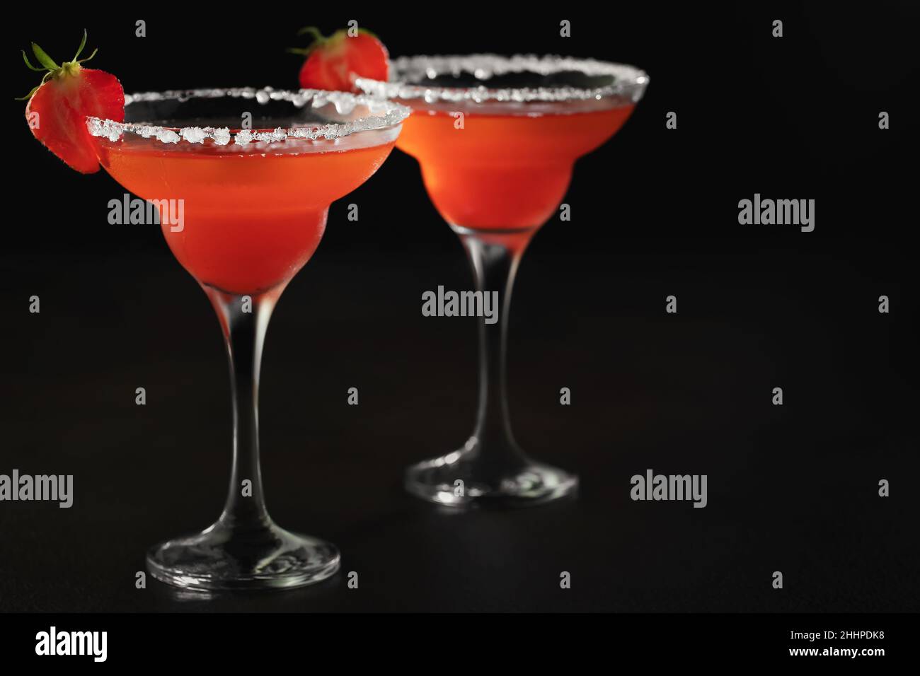 Fresh homemade refreshing strawberry cocktail margarita in glasses on the table with copy space. Stock Photo