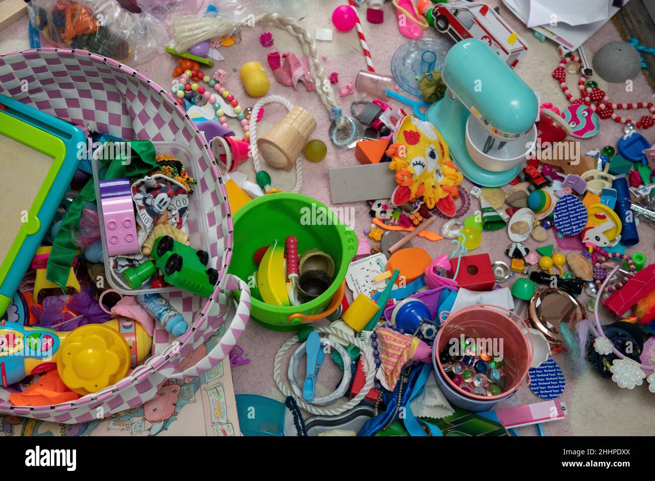 Assorted miscellaneous small children’s toys on a carpet Stock Photo