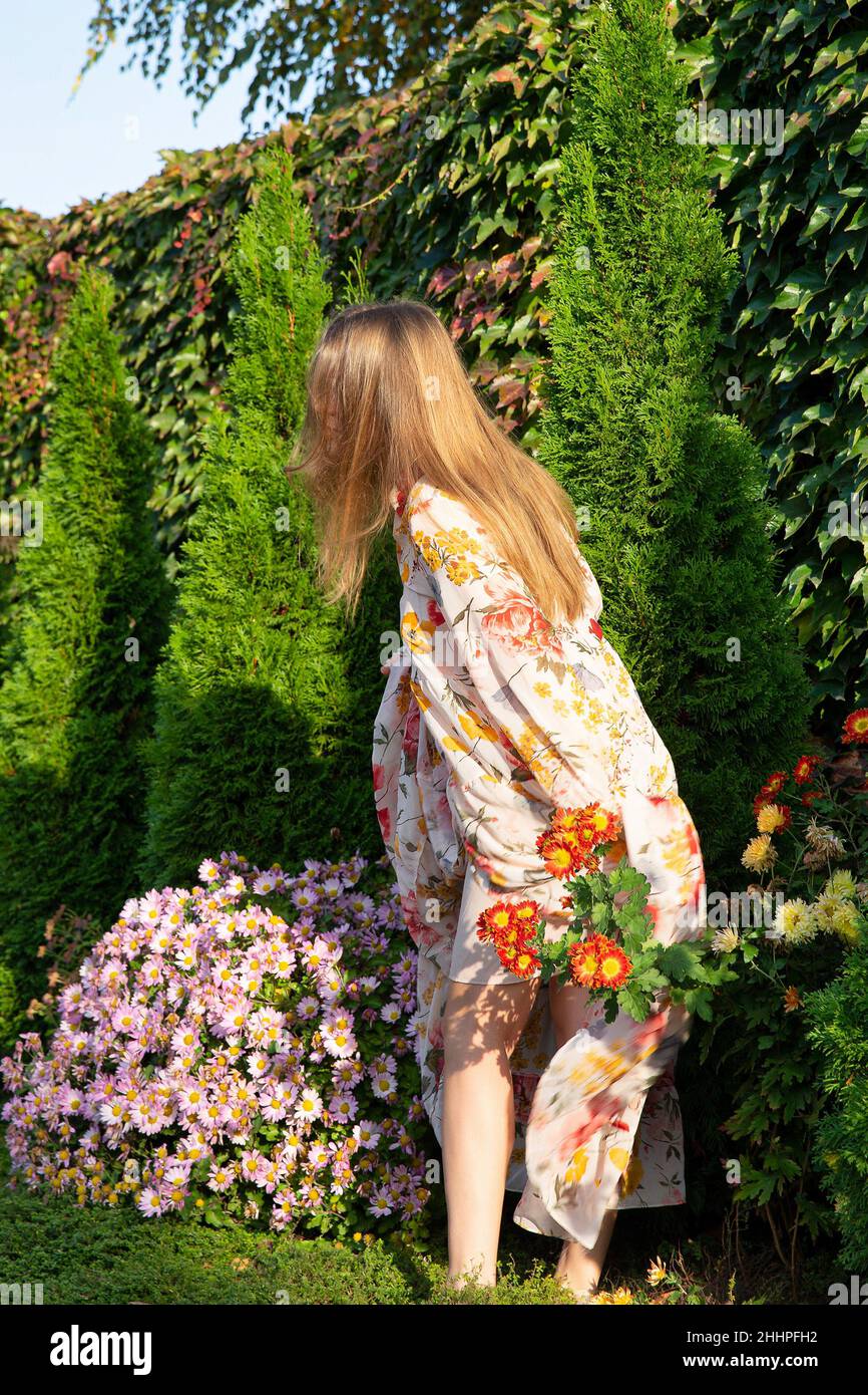 Young woman walking in formal garden hi-res stock photography and ...