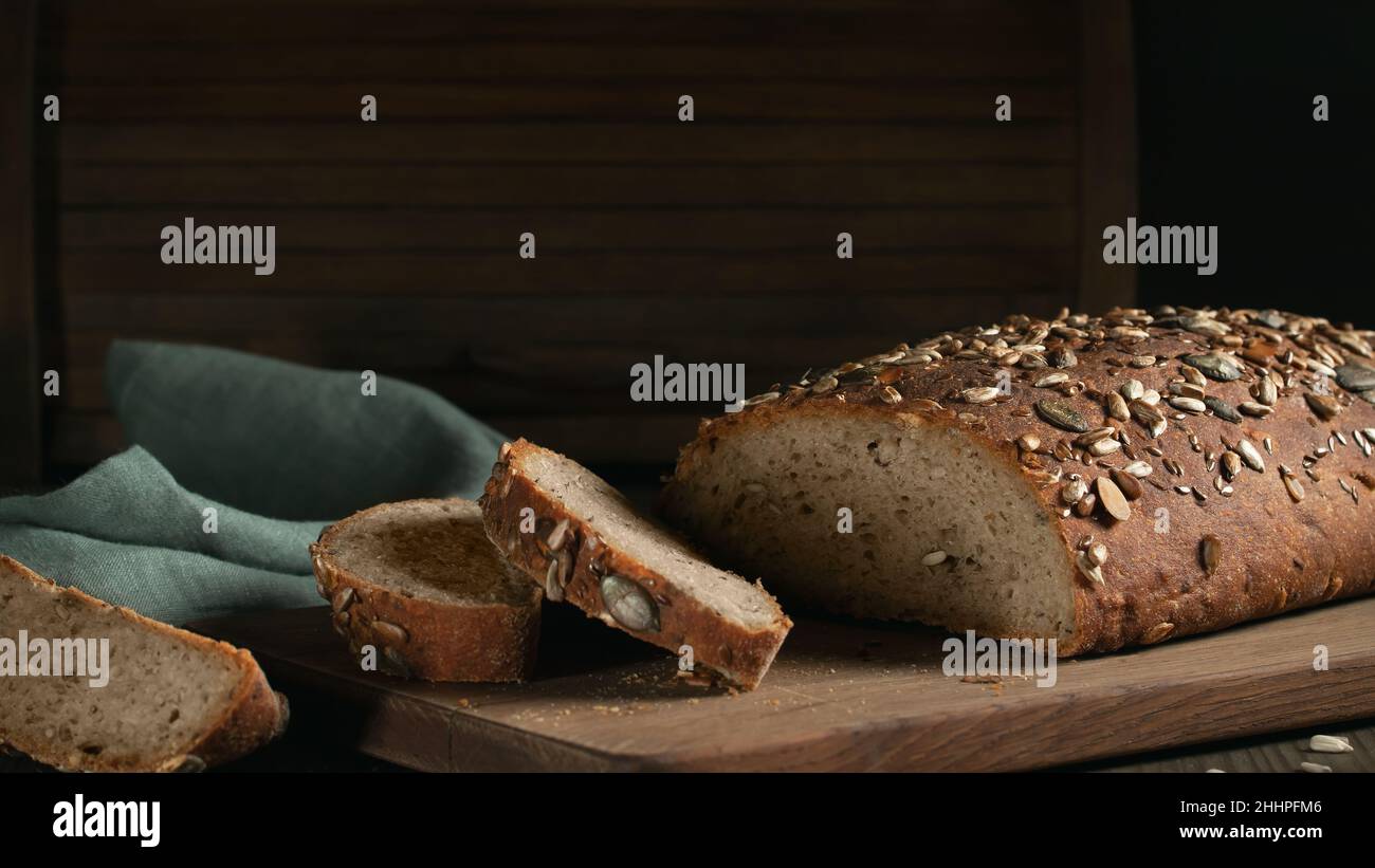 Sliced Homemade Whole Grain Bread with Seeds on a Cutting Board. Stock Photo