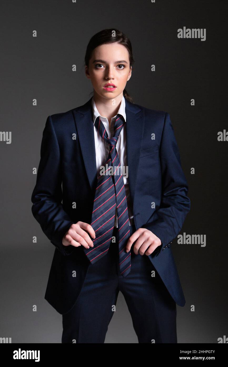 Woman in suit grey background hi-res stock photography and images - Alamy