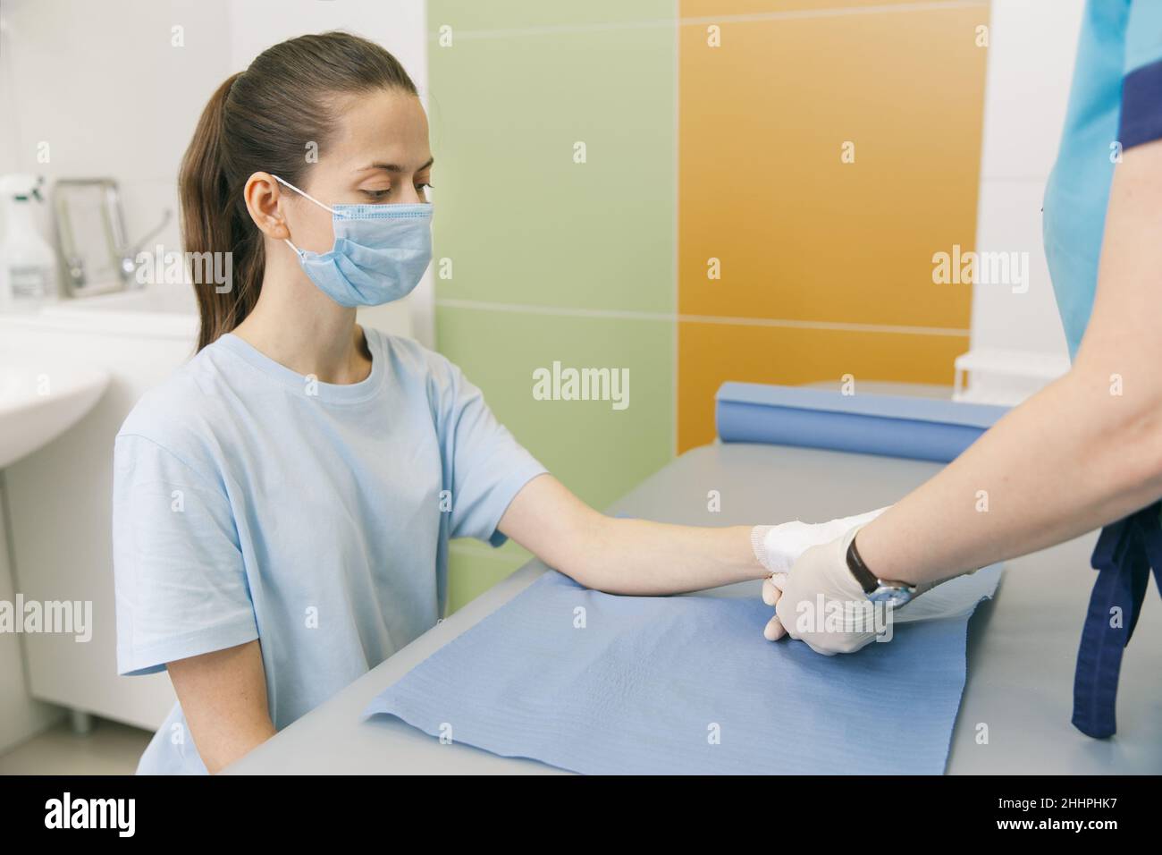 A doctor wrapped around the wrist for first aid close-up. Application of bandages on the patient's hands, first aid concepts and wrist injury Stock Photo