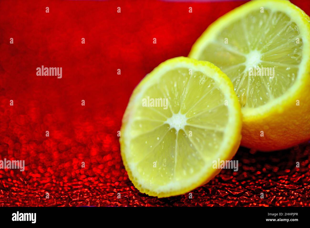 lemon slice on a red shiny enamelled plate Stock Photo