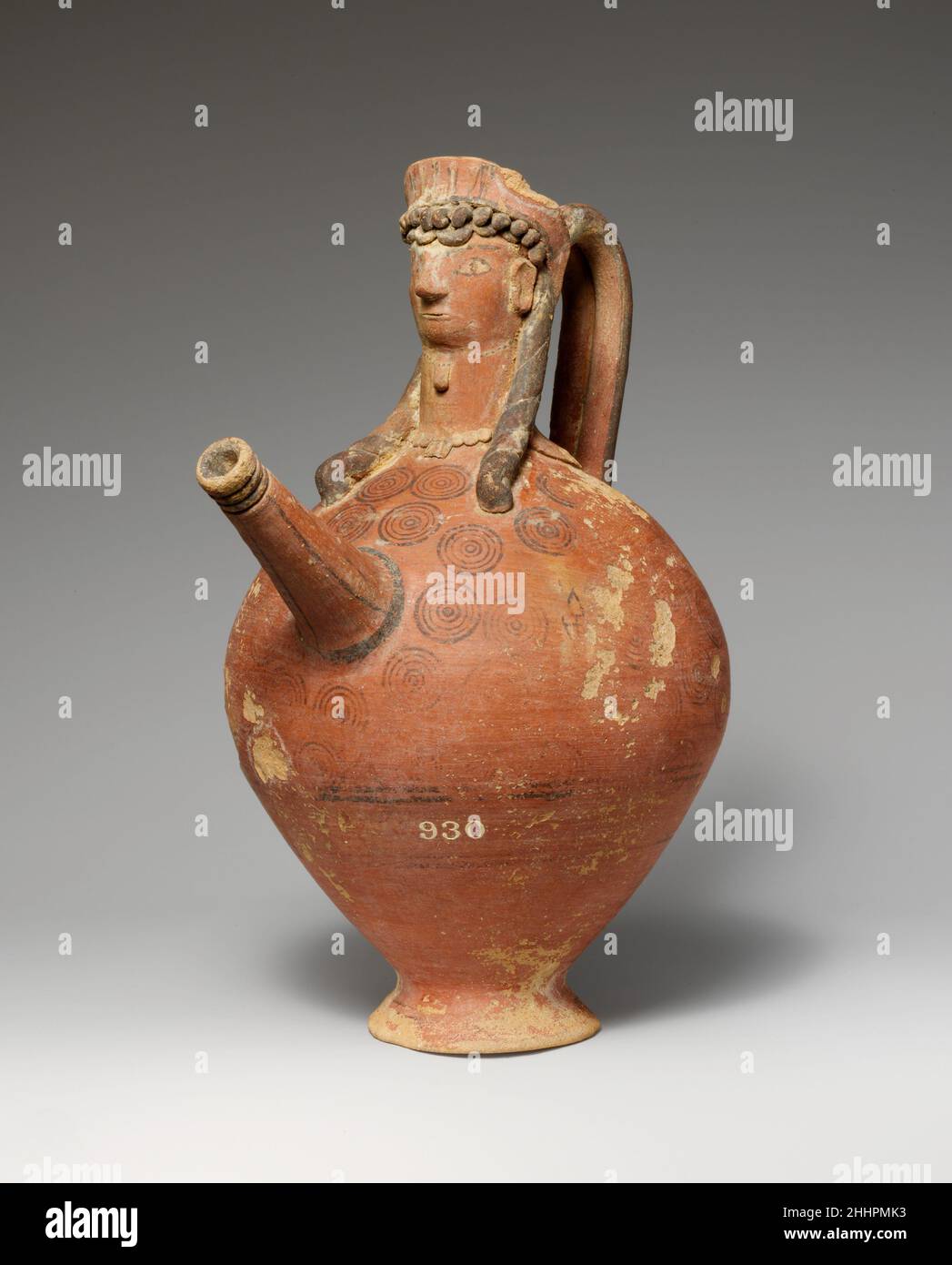 Terracotta trick vase 750–600 B.C. Cypriot The spout and neck are in the form of a woman's head. The 'trick' in the vase consists of a hole in the underside of the foot. When the opening was unplugged, the contents of the vase would flow out.. Terracotta trick vase  240155 Stock Photo