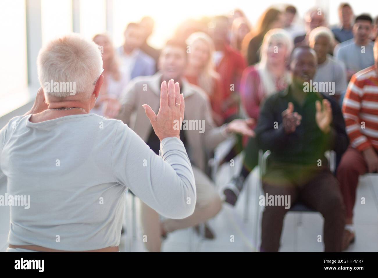 successful older woman talking about something at a business training Stock Photo