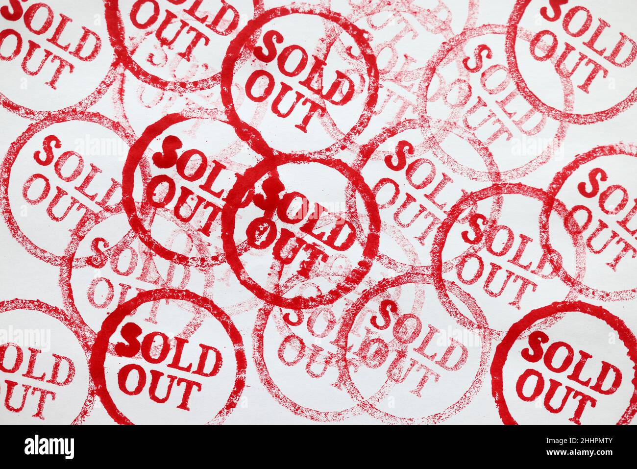 Many red stamps sold out on paper closeup background Stock Photo - Alamy