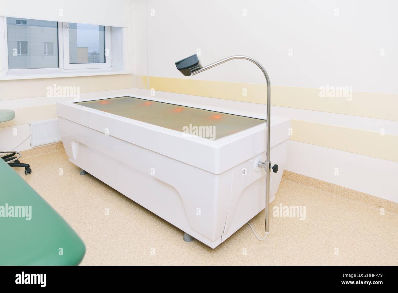 Massage table in clinic room. Hospital rehabilitation center. Modern medical equipment, preventional medicine concept. Modern hospital laboratory Stock Photo