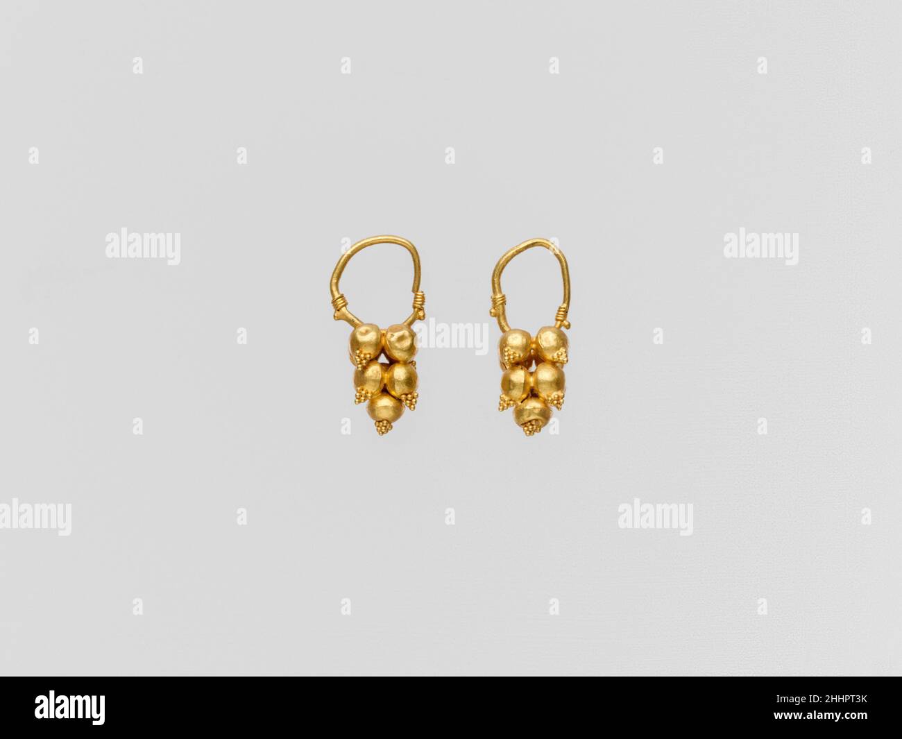 Gold earring with clustered spheres and pyramidal granulation 2nd–3rd century A.D. Roman Gold earrings with mulberry ornament.. Gold earring with clustered spheres and pyramidal granulation. Roman. 2nd–3rd century A.D.. Gold. Imperial. Gold and Silver Stock Photo