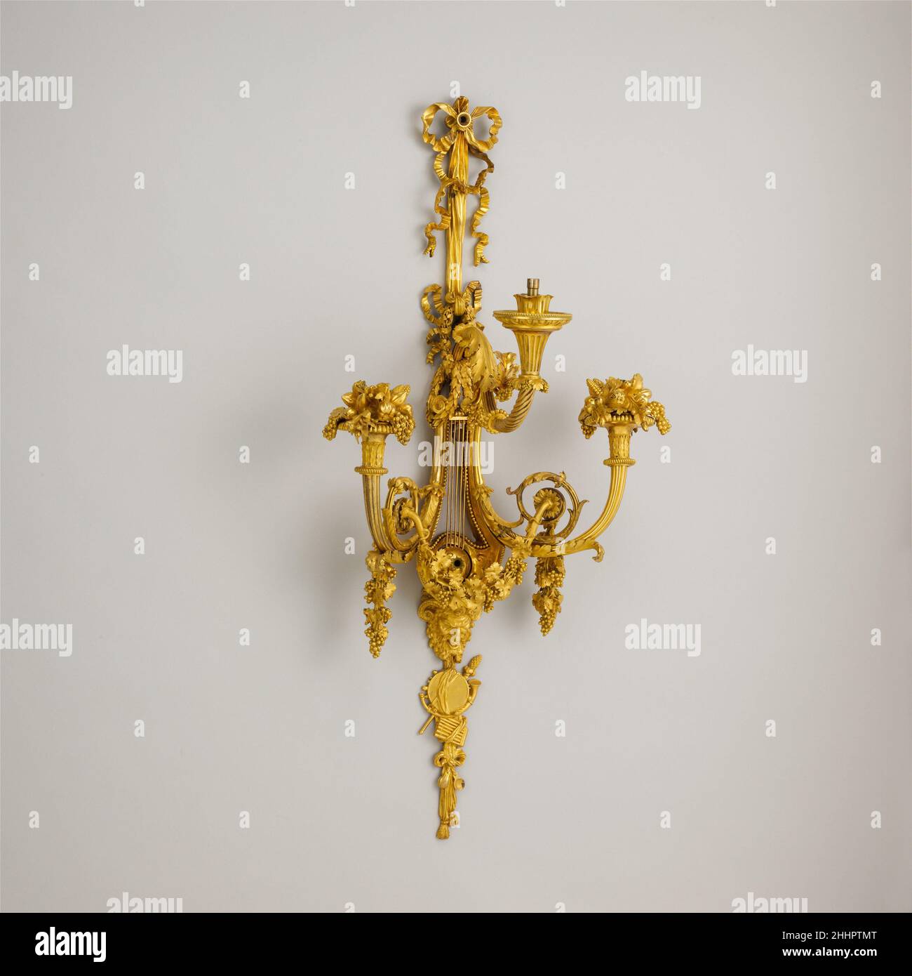 Set of four three-light sconces (bras de lumière) ca. 1787–88 French, Paris Music was one of Marie-Antoinette’s lifelong diversions. She was taught to perform and sing when young in Vienna, where the opera composer Christoph Willibald Gluck (1714–1787) was her tutor. She amused herself with music several hours a day at the French court and was a devotee of the opera. The queen’s enjoyment of music is reflected in the design of these wall lights, which were ordered probably in 1787 or the following year for her use at the Château de Saint-Cloud. Although no precise date or authorship have been Stock Photo