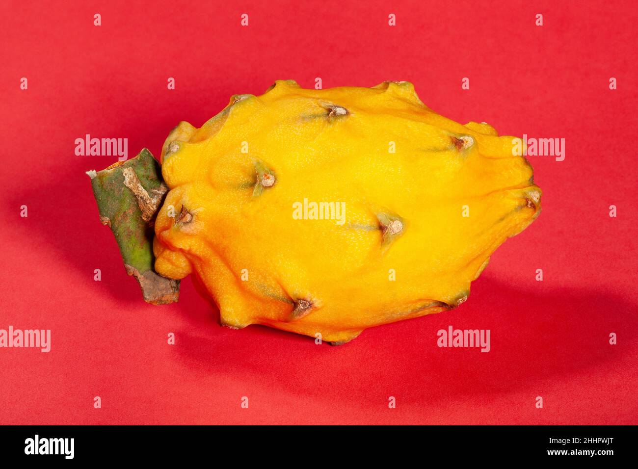 yellow dragon fruit on red background Stock Photo